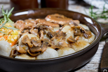 Stewed pork chop in a bright mushroom sauce.
