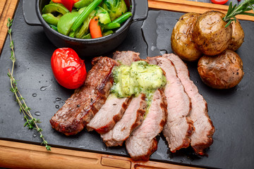 Juicy steak medium rare beef with spices and grilled vegetables
