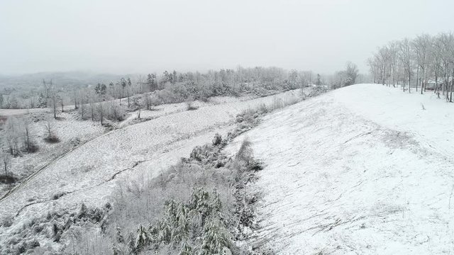 Wide aerial, Kentucky countryside covered in snow