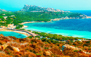 Landscape and road at Capo Testa at Santa Teresa Gallura in Sardinia Island in Italy, summer. Cars...