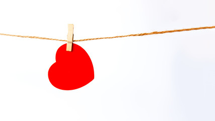 Red heart pinned isolated on white background. Valentine's Day concept, close-up. Place for text.