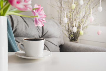 Morning black coffee in spring interior. Easter party planning