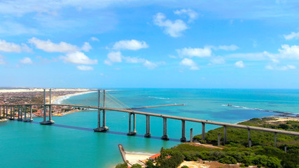 Obraz premium Suspension Bridge in Natal, Brazil and colorful blue water of Atlantic ocean. 