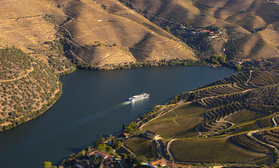Cruise ship in Douro river and Alto Douro vineyards and landscape - UNESCO World Heritage