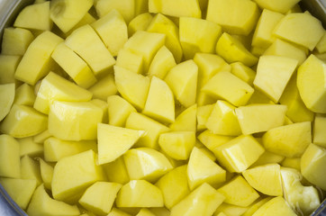Cut peeled raw potato in the water. Top view