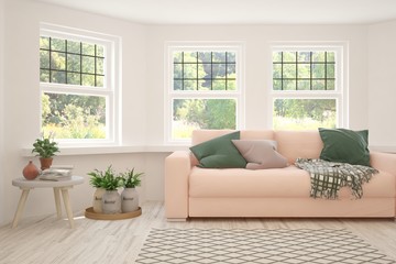Fototapeta premium Stylish room in white color with sofa and summer landscape in window. Scandinavian interior design. 3D illustration