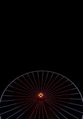 Ferris wheel at night carnival entertainment place hear shape lamp illumination frame black background empty copy space for text, vertical picture