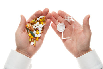 Man hand opening glass bottle full of pills, tablets, vitamins, drugs, capsules isolated on white background. White shirt, business style. Health care concept. Pharmaceutical industry. Pharmacy.