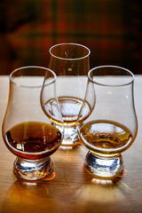 Scotch whisky, tasting glasses with variety of single malts or blended whiskey spirits on distillery tour in Scotland