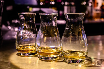 Scotch whisky, tasting glasses with variety of single malts or blended whiskey spirits on distillery tour in Scotland