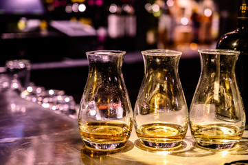 Scotch whisky, tasting glasses with variety of single malts or blended whiskey spirits on distillery tour in Scotland