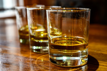 Scotch whisky, tasting glasses with variety of single malts or blended whiskey spirits on distillery tour in Scotland