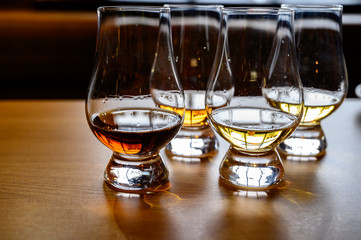 Scotch whisky, tasting glasses with variety of single malts or blended whiskey spirits on distillery tour in Scotland