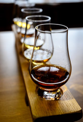 Scotch whisky, tasting glasses with variety of single malts or blended whiskey spirits on...