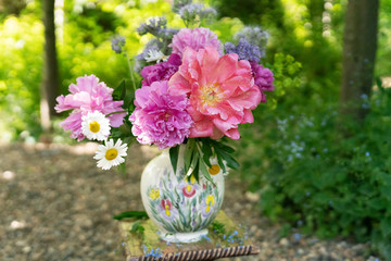bouquet of flowers in vase on white background