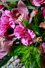 Floral arrangement with orchids, carnations and brunia flowers.