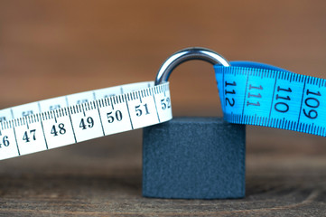 lock and measuring ruler, the secret of weight loss, the concept of proper nutrition