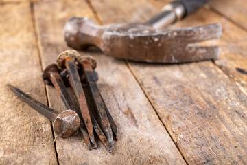 Old rusty nails on a workbench. Steel elements forged in old technology for joining wood.