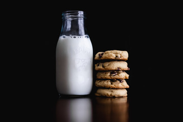 Glass Bottle of Milk and Chocolate Chip Cookies