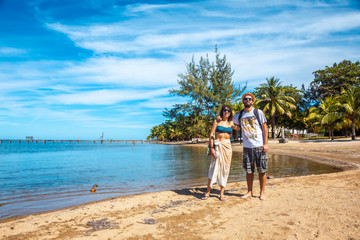 Two young men on the beach of Sandy Bay on Roatan Island. Honduras