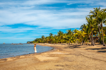 A young girl on the beach of Sandy Bay on Roatan Island. Honduras