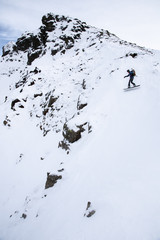 Snowboarder in steep couloir