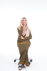 Fototapeta premium Female student in various poses wearing modern kurung, a modern urban lifestyle apparel for Muslim women isolated on white background. Beauty and hijab fashion concept.