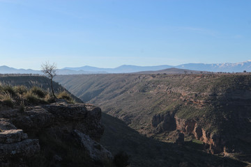 Scenic view of the Gor river valley and Sierra Nevada mountains on the background, Spain