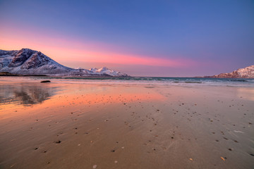 Fototapeta premium Amazing sunrise with amazing magenta color over sand beach. Tromso, Norway . Polar night. long shutter speed
