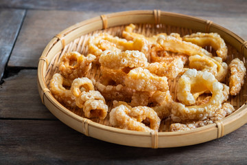 Pork rind, pork crackling in round bamboo tray.