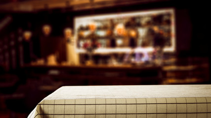 Fototapeta premium desk of free space and blurred bar interior 