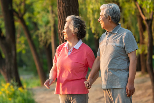 The happiness of the elderly couple walking in the park