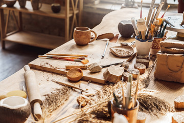 Craftsperson Workspace. Table with materials and tools for pottery isolated creative studio side...