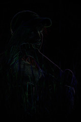 young girl with long hair in a baseball cap at night