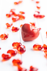 Red hearts on white table.