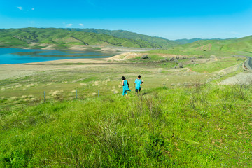 a girl and a boy on a hill