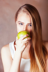 young pretty blond woman holding green apple smiling slim, lifestyle people concept