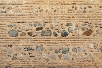 Old brick and stone wall. Multilayered wall with a square detail