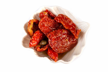 Sun dried tomatoes ceramic bowl. White background. Top view.