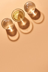 Glasses with clear water isolated on orange .Orange background. Top view.