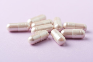 Carnitine capsules. Concept for a healthy dietary supplementation. Bright paper background. Close up. Copy space. 