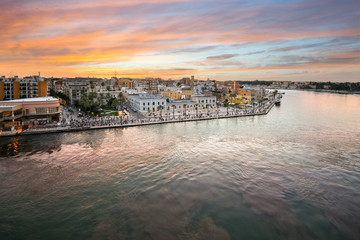 View from a cruise ship as the Piazza Vittorio Emanuele II fills with tourists enjoying a late summer evening sunset at the port city, Brindisi Italy