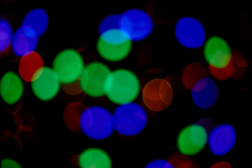 Red and orange, green, blue bokeh. Abstract background. Dark background.