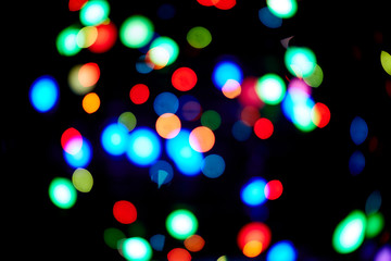 Red and orange, green, blue holliday bokeh. Abstract background