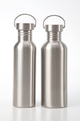 metal steel water flasks on white background. metal drinking utensils