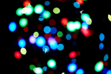 Red and orange, green, blue holliday bokeh. Abstract background