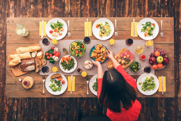 Woman bring tasty food for family dinner at christmas eve