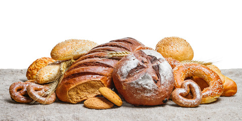 Fresh bread and bakery on sackcloth with white background, with space for text