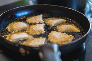 fried Portuguese or Brazilian rissoles in a frying pan