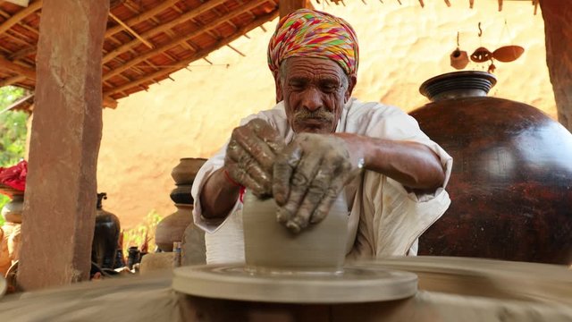 Potter at work makes ceramic dishes. India, Rajasthan.